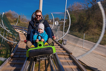 Image showing young father and son driving alpine coaster