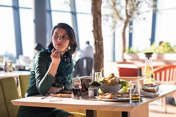 Image showing young woman  having lunch at restaurant