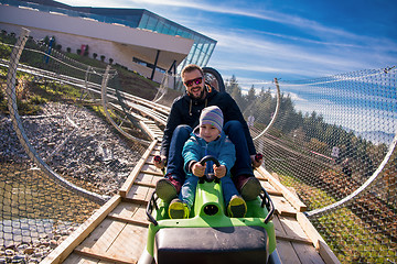 Image showing young father and son driving alpine coaster