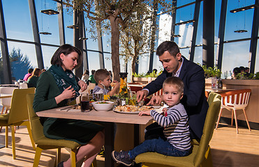 Image showing happy family enjoying lunch time together