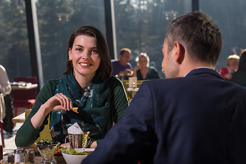 Image showing youn couple enjoying lunch at restaurant