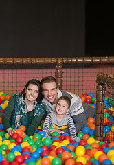 Image showing parents and kids playing in the pool with colorful balls