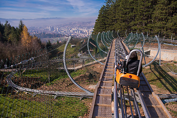 Image showing young mother and son driving alpine coaster