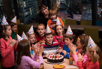 Image showing happy young boy having birthday party