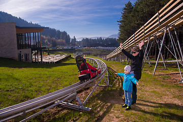 Image showing Happy family enjoying alpine coaster