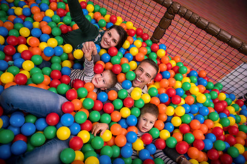 Image showing parents and kids playing in the pool with colorful balls