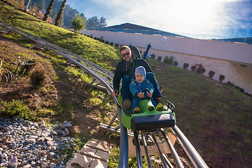 Image showing young father and son driving alpine coaster