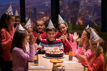 Image showing happy young boy having birthday party