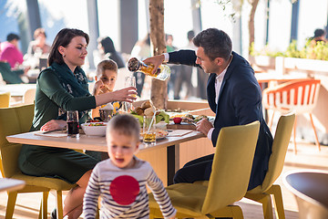 Image showing happy family enjoying lunch time together