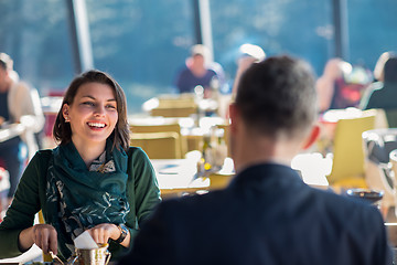 Image showing youn couple enjoying lunch at restaurant