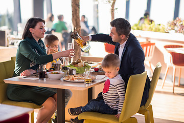 Image showing happy family enjoying lunch time together