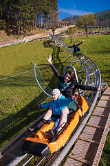 Image showing young mother and son driving alpine coaster