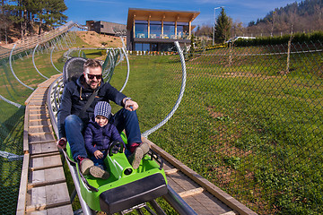 Image showing young father and son driving alpine coaster