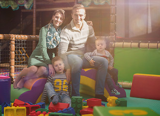 Image showing young parents and kids having fun at childrens playroom