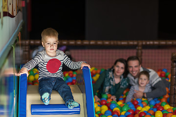 Image showing parents and kids playing in the pool with colorful balls