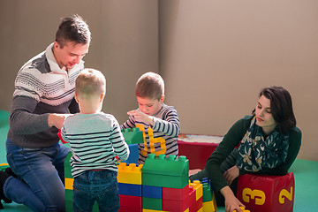 Image showing young parents and kids having fun at childrens playroom