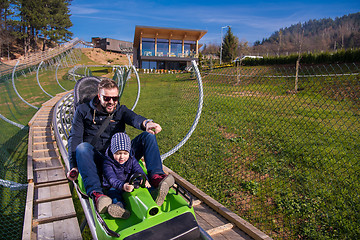 Image showing young father and son driving alpine coaster