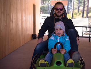 Image showing young father and son driving alpine coaster