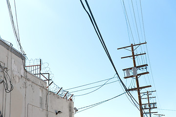 Image showing transmission tower and power line over blue sky