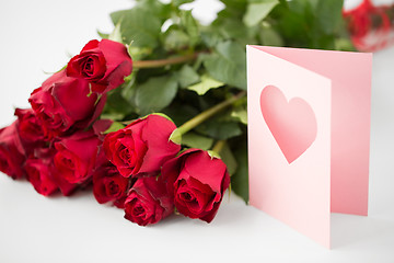 Image showing close up of red roses and greeting card with heart