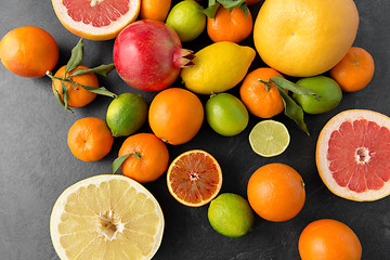 Image showing close up of citrus fruits on stone table