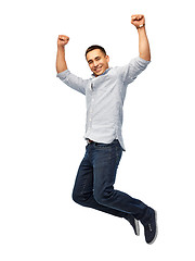 Image showing happy young man jumping over white background