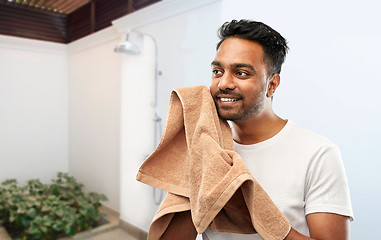 Image showing smiling indian man with bath towel over shower