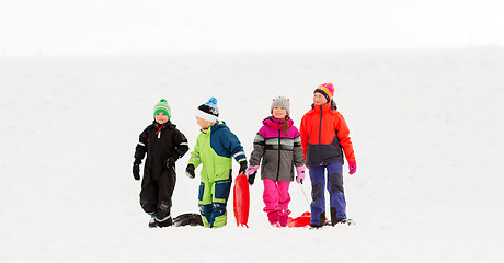 Image showing happy little kids with sleds in winter