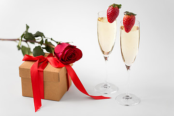 Image showing two champagne glasses and gift with red rose