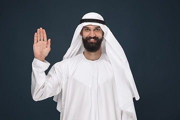 Image showing Arabian saudi businessman on dark blue studio background