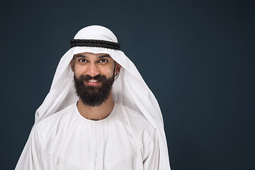 Image showing Arabian saudi businessman on dark blue studio background