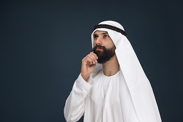 Image showing Arabian saudi businessman on dark blue studio background