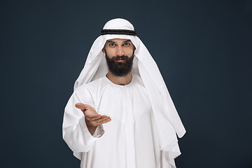 Image showing Arabian saudi businessman on dark blue studio background