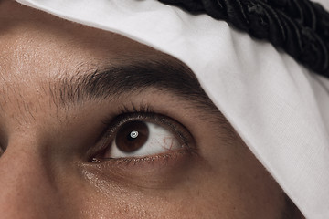 Image showing Arabian saudi man on dark blue studio background