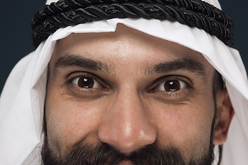 Image showing Arabian saudi man on dark blue studio background