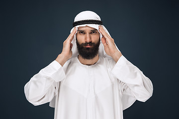 Image showing Arabian saudi man on dark blue studio background