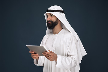 Image showing Arabian saudi businessman on dark blue studio background