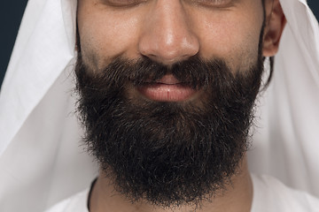 Image showing Arabian saudi man on dark blue studio background