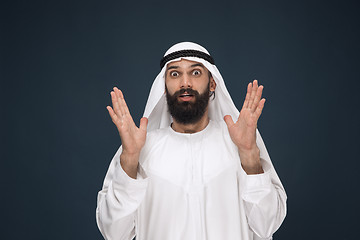 Image showing Arabian saudi man on dark blue studio background