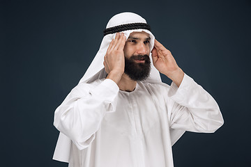 Image showing Arabian saudi man on dark blue studio background