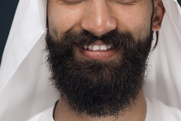 Image showing Arabian saudi man on dark blue studio background