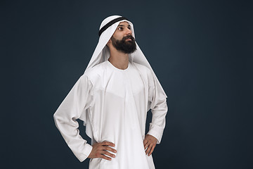 Image showing Arabian saudi businessman on dark blue studio background