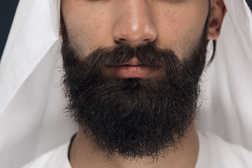 Image showing Arabian saudi man on dark blue studio background