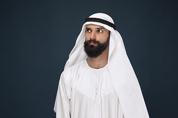 Image showing Arabian saudi businessman on dark blue studio background