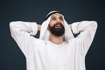 Image showing Arabian saudi businessman on dark blue studio background