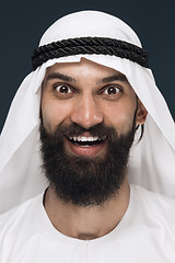 Image showing Arabian saudi man on dark blue studio background