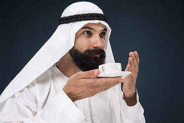 Image showing Arabian saudi man on dark blue studio background