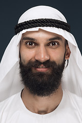 Image showing Arabian saudi man on dark blue studio background