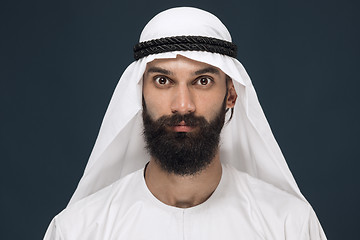 Image showing Arabian saudi man on dark blue studio background