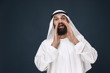 Image showing Arabian saudi man on dark blue studio background